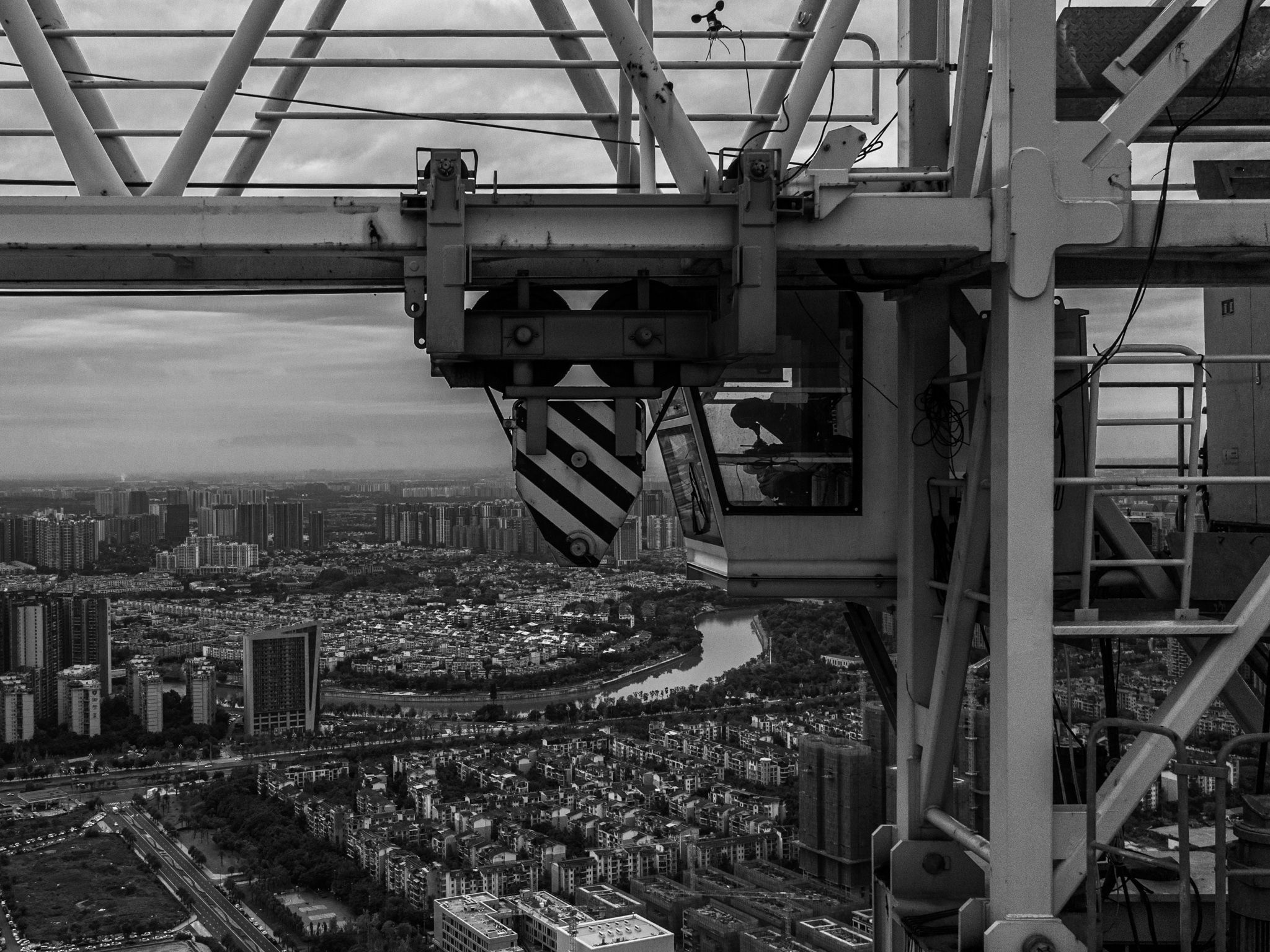 construction crane, city, megalopolis, black and white, tall buildings, river, bird's eye view, aerial view, Druz Denys