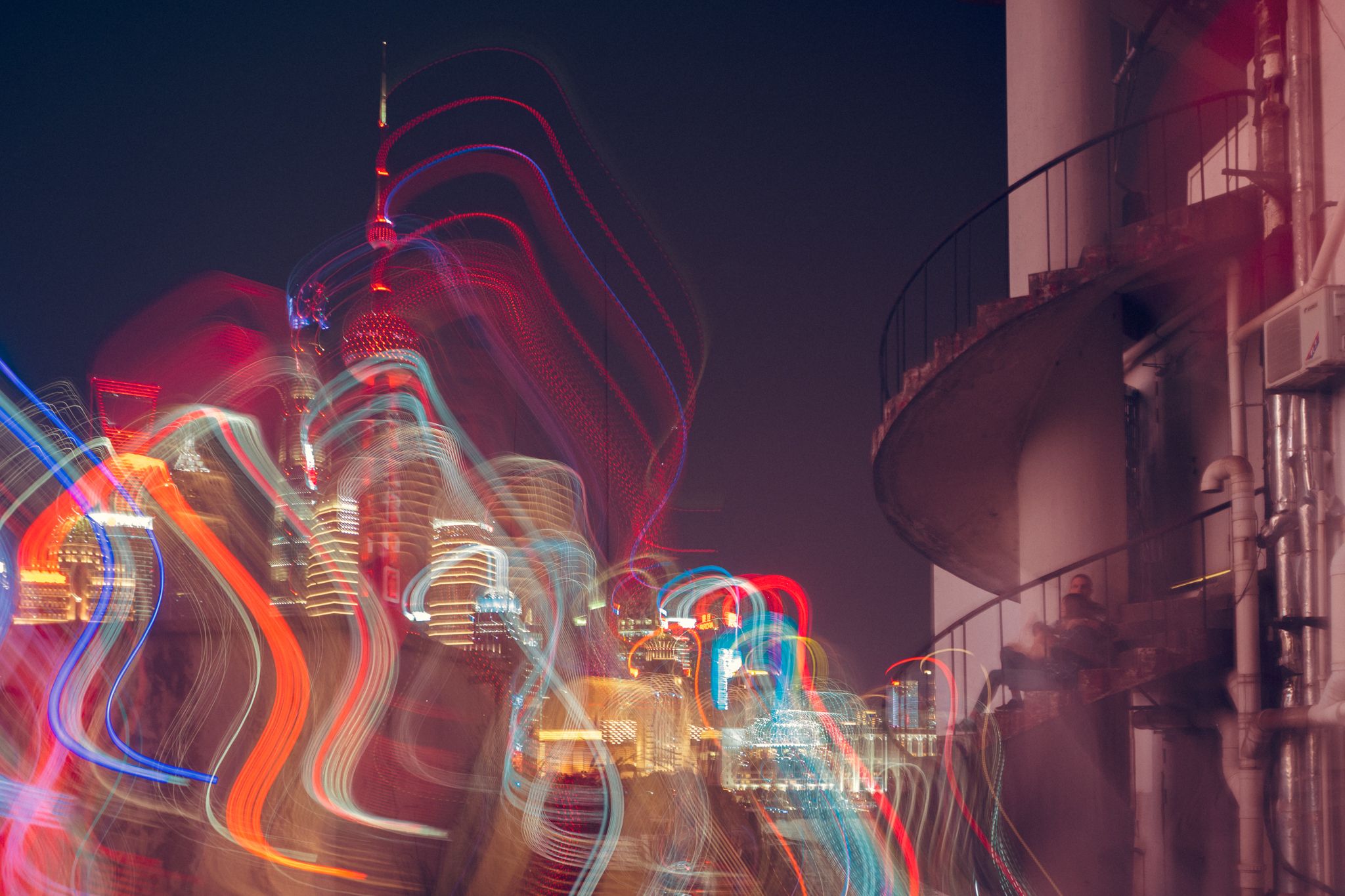 city lights, vibrant buildings, light trails, colorful palette, spiral staircase, hotel emergency exit, light show, metropolis skyline, urban night scene, couple watching lights, cityscape photography, night skyline view, urban trails of light, colorful u, Druz Denys