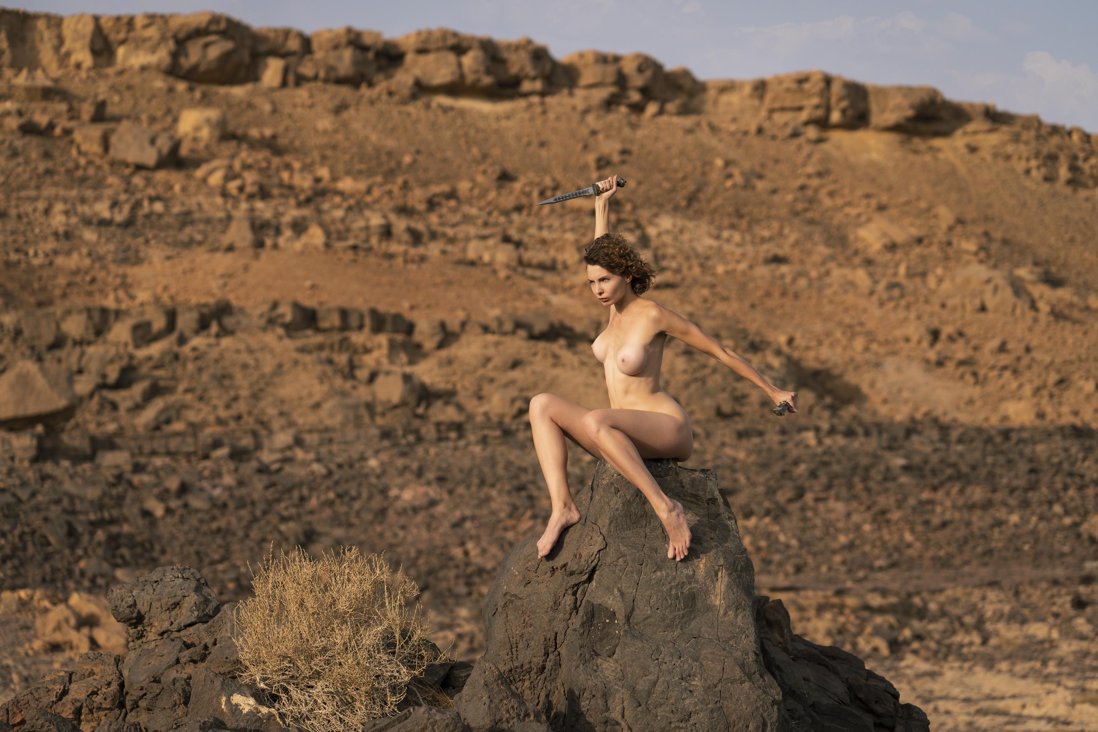 attractive, beautiful woman, beauty, dagger, desert, dry, eyes, female, grace, hair, hands, individuality, legs, look, makhtesh ramon, naked, nude, one person, outdoors, pose, rocks, sensuality, side view, sitting, sky, stones, young women, Alex Tsarfin