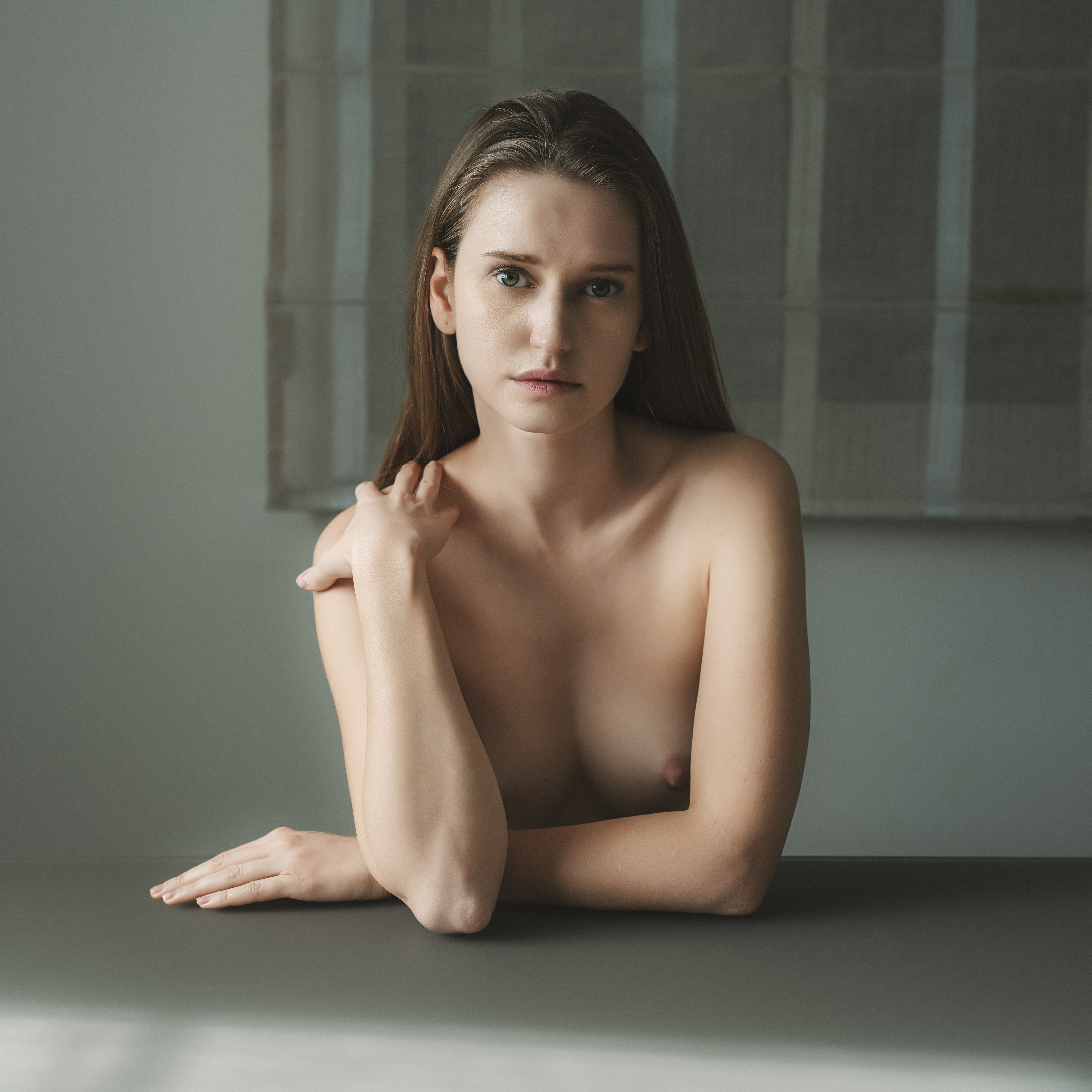 artnude, attractive, beautiful woman, beauty, curtain, dreaminess, female, femininity, front view, individuality, indoors, lifestyles, looking at camera, naked, nude, one person, portrait, seductive women, sensuality, sitting, table, window, young women, Alex Tsarfin