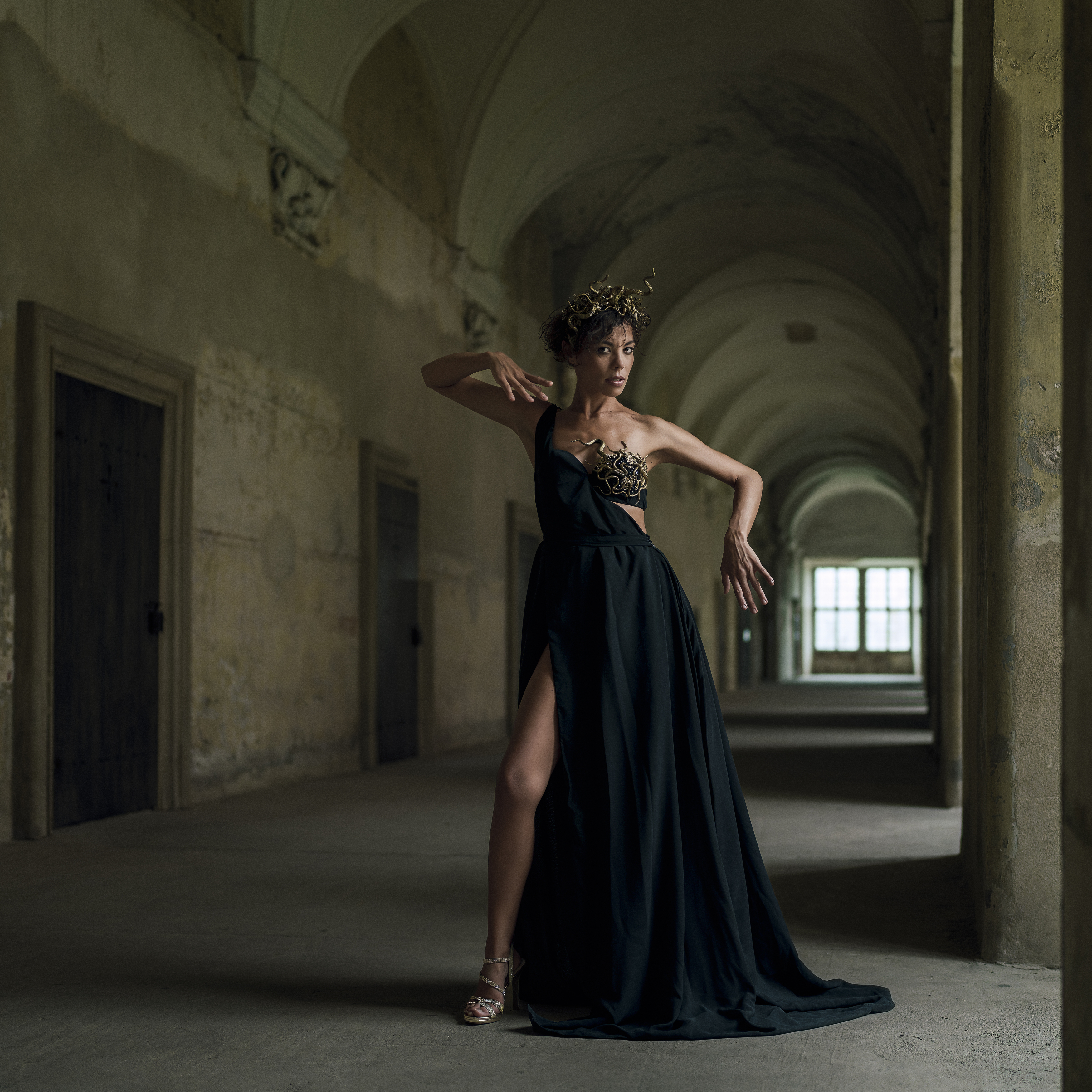 ancient aesthetics, artistic portrait, baroque architecture, cinematic lighting, dramatic photography, emotional depth, front view, golden headdress, historic interior, light and shadow, looking at camera, one person, standing, window, woman, Alex Tsarfin