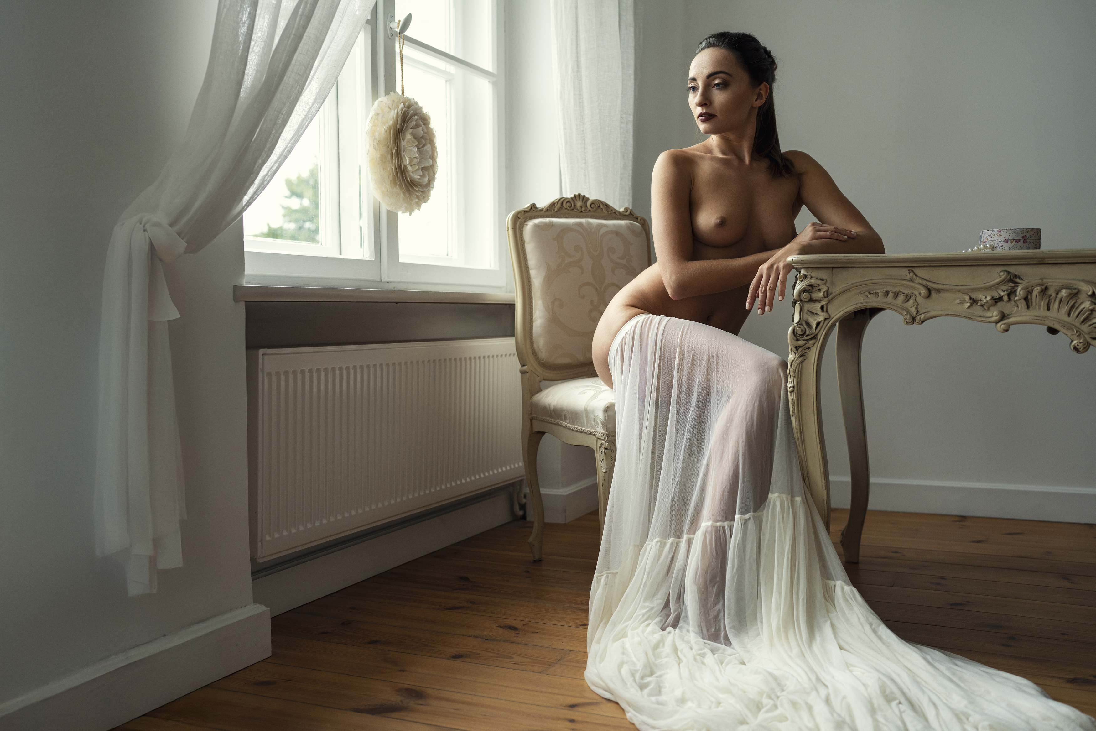 art nude, baroque chair, boudoir elegance, contemplative gaze, draped fabric, feminine grace, fine art, intimate scene, nude sitting, poetic nude, romantic atmosphere, sensual grace, serene mood, vintage setting, window light, wooden floor, Alex Tsarfin