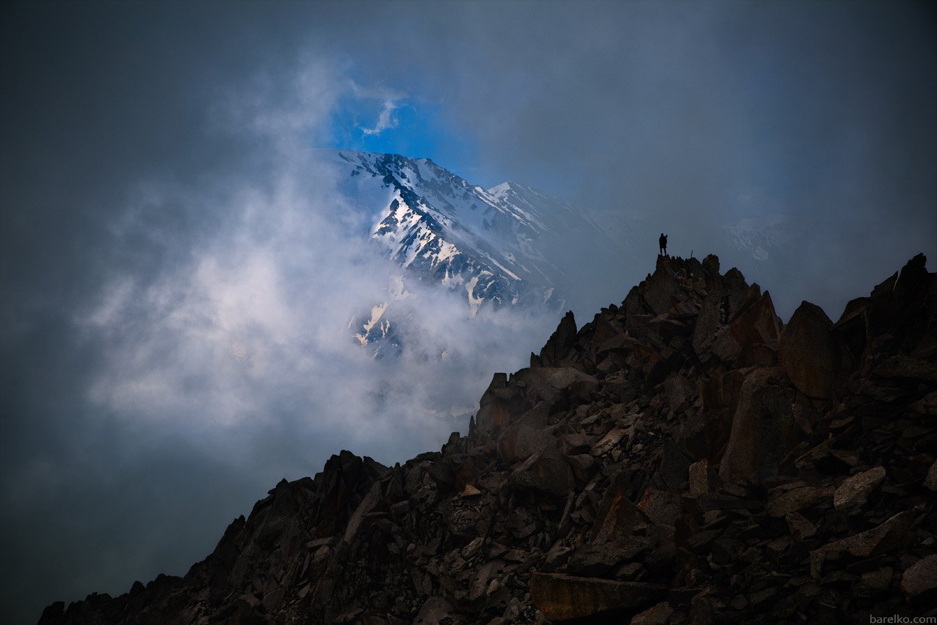 Big, Almaty, Peak, with, hiker, on, top, Roman Barelko