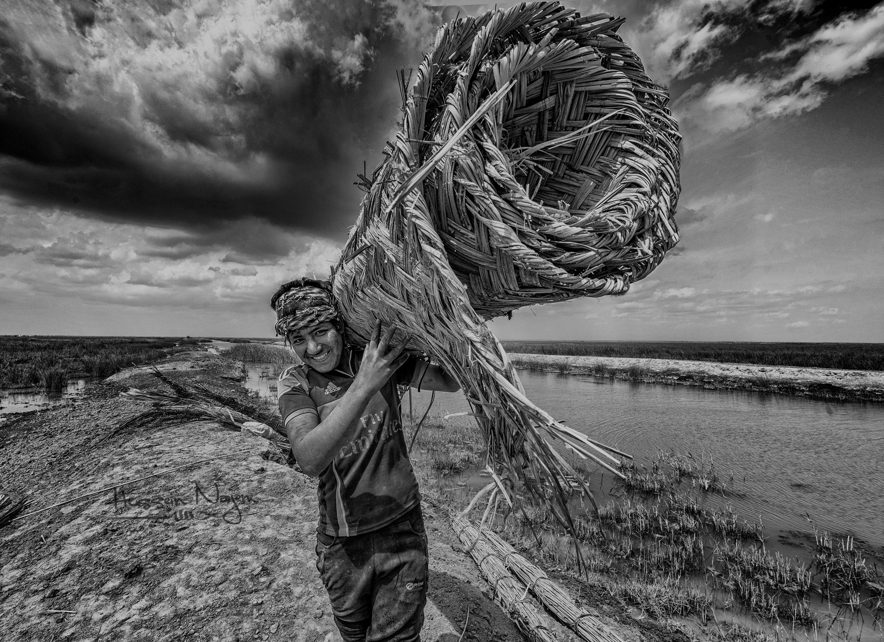 Marshes,Southern Iraq,Boy,cane,Water.sky,black and white, hussein