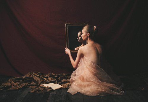 Woman with book and mirror
