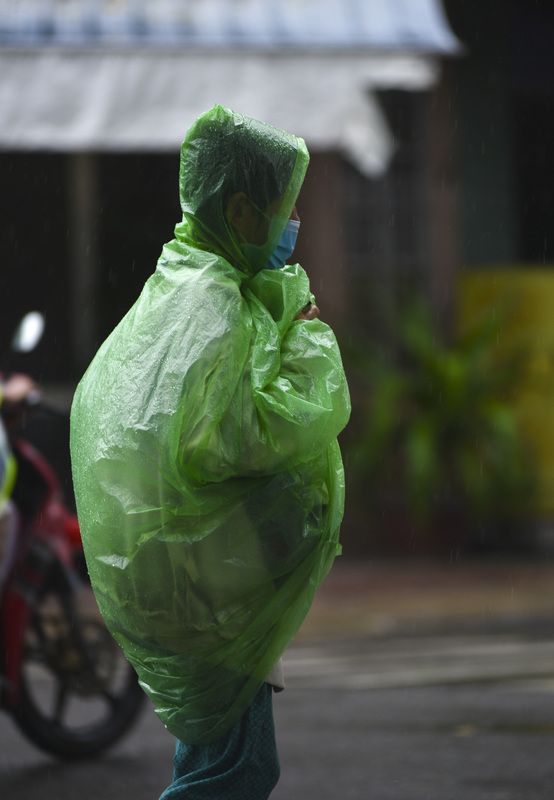 Raincoat on the VietNam streetsphoto preview