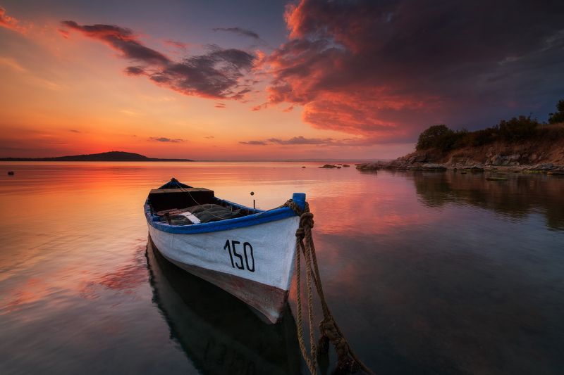 Lonely boat at sunsetphoto preview