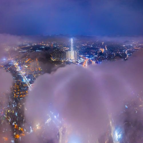 The tallest building in Vietnam is covered with clouds.